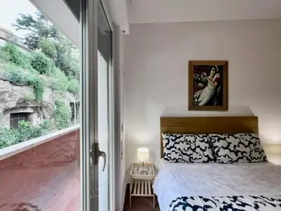 a kitchen with white cabinets and a table and chairs at Inn Trastevere Home in Rome