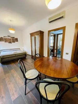 a room with a table and chairs and a bed at Martina al Colosseo in Rome