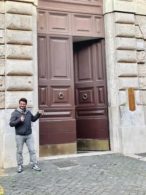 a man standing in front of a large wooden door at Martina al Colosseo in Rome