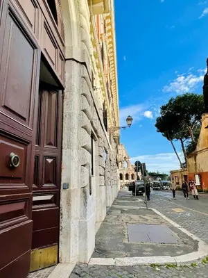 a building with a brown door on the side of a street at Martina al Colosseo in Rome