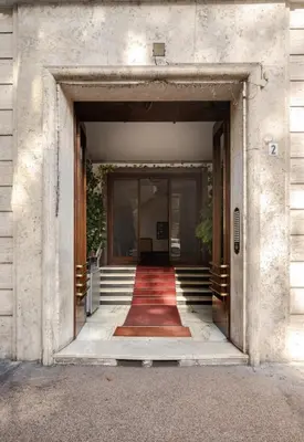 an open door of a building with a red carpet at Suite Guido Reni in Rome