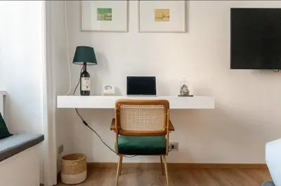 a room with a desk with a chair and a laptop at Suite Guido Reni in Rome