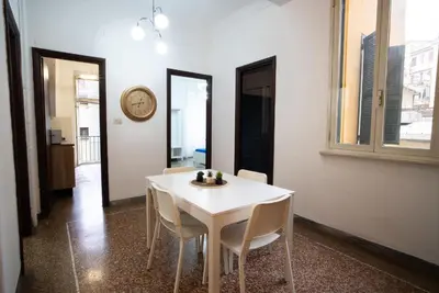 a white table and chairs in a room with a clock at Optima mansio in Rome