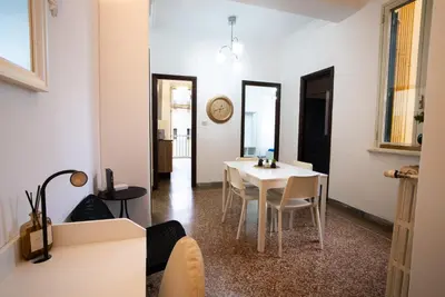 a dining room with a white table and chairs at Optima mansio in Rome