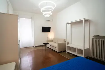 a room with a bed and a chair and a lamp at Optima mansio in Rome
