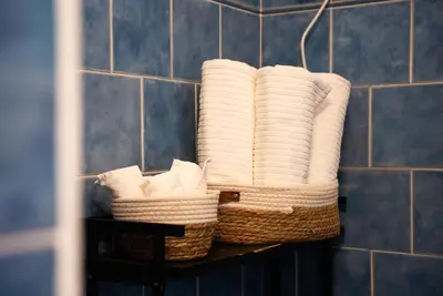 a group of towels in baskets on a shelf in a bathroom at Optima mansio in Rome