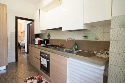 a kitchen with white cabinets and a sink at Optima mansio in Rome