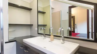 a bathroom with a sink and a mirror at Panorama Penthouse by Rental in Rome in Rome