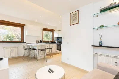 a kitchen and living room with a table and chairs at Panorama Penthouse by Rental in Rome in Rome