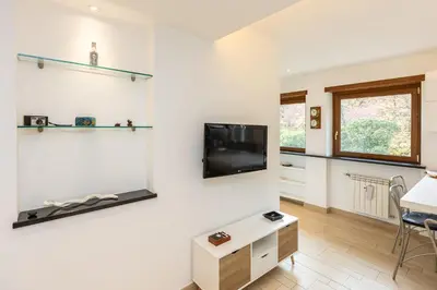 a living room with a flat screen tv on a wall at Panorama Penthouse by Rental in Rome in Rome