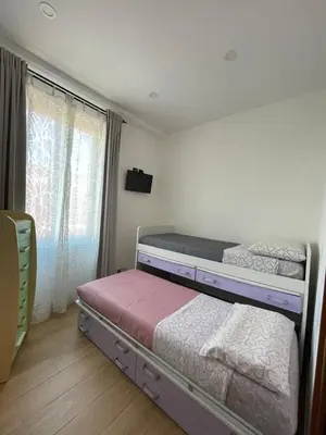 a bedroom with a bed and a dresser and a mirror at Fabio´s Holiday House in Rome
