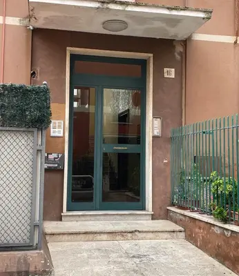 a balcony with potted plants and a building at Fabio´s Holiday House in Rome