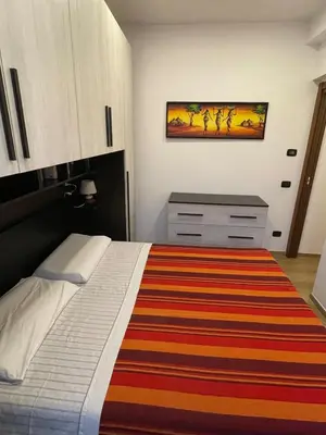 a bedroom with a bed with a striped rug at Fabio´s Holiday House in Rome
