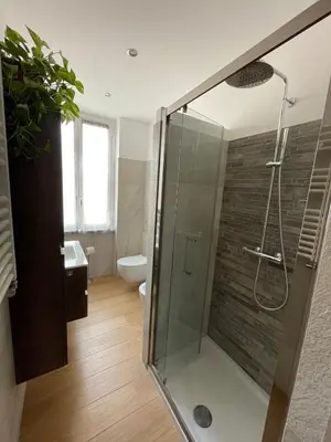 a bathroom with a glass shower with a toilet at Fabio´s Holiday House in Rome