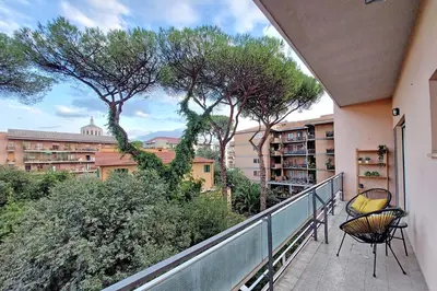 a balcony with chairs and trees and buildings at Carmens Flat by DomusDimore in Rome
