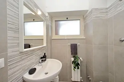 a bathroom with a sink and a mirror at Carmens Flat by DomusDimore in Rome