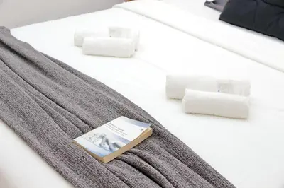 a book sitting on top of a bed with towels at Carmens Flat by DomusDimore in Rome