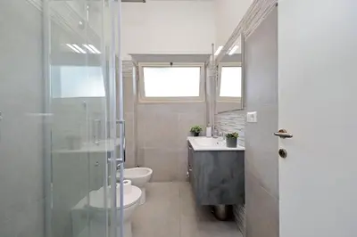 a bathroom with a toilet and a sink and a shower at Carmens Flat by DomusDimore in Rome