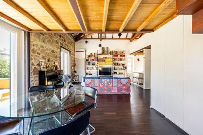 a dining room and kitchen with a glass table and chairs at Loft in Garbatella in Garbatella