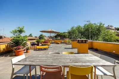 a wooden table and chairs on a patio at Loft in Garbatella in Garbatella