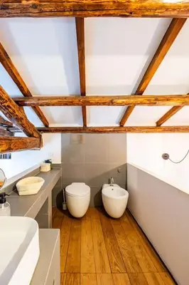 a bathroom with two sinks and a toilet at Loft in Garbatella in Garbatella