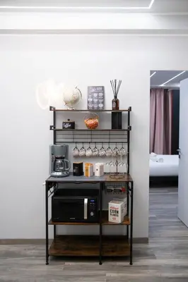 a black shelf with a microwave on it at New Luxury Rooms in Rome