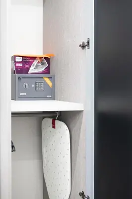a shelf above a toilet with a box on it at New Luxury Rooms in Rome