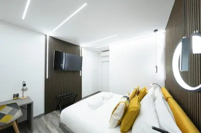 a hotel room with a bed and a tv at New Luxury Rooms in Rome