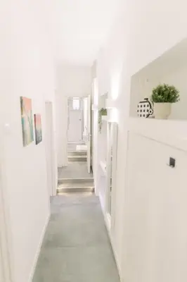 a hallway with white walls and a white hallway with white floors at Atella Rome Apartment in Rome