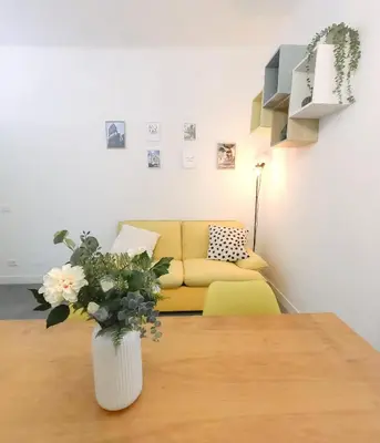 a living room with a yellow couch and a table at Atella Rome Apartment in Rome
