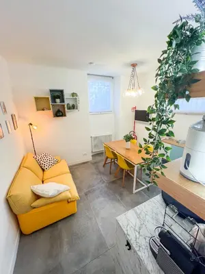 a living room with a yellow couch and a table at Atella Rome Apartment in Rome