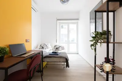 a bedroom with a desk with a laptop on it at Domus Trionfale - 8 min walk to Vatican, 500mt to Metro A, A-C in Rome