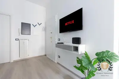 a living room with a tv on a white wall at Domus Trionfale - 8 min walk to Vatican, 500mt to Metro A, A-C in Rome