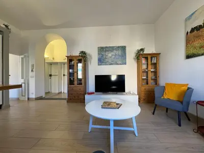 a living room with a table and a tv at Green Oasis in Villa Riccio in Rome