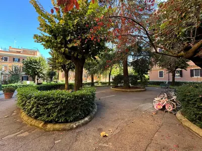 a pink bike parked in a park with trees at Green Oasis in Villa Riccio in Rome