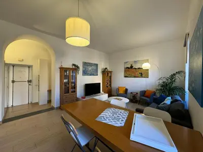 a living room with a table and a couch at Green Oasis in Villa Riccio in Rome