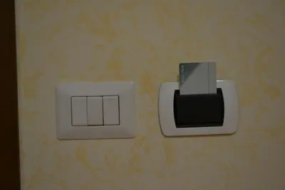 two electrical switches are attached to a wall at Tucci's Roma Guest House in Rome