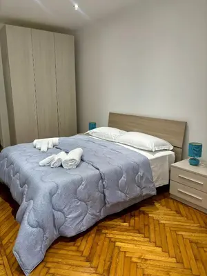 a bedroom with a large bed with towels on it at Dimora Sistina Roma in Rome