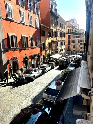 a street with cars parked on the side of the road at Dimora Sistina Roma in Rome