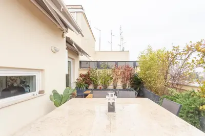 a table with a candle on it on a patio at Elegant apartment metro A - by OpenRoma in Rome