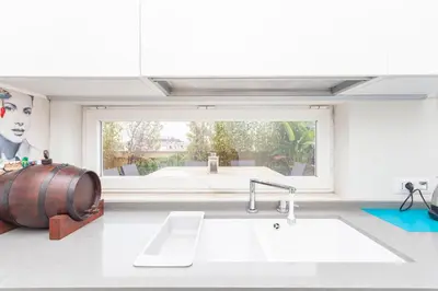a kitchen with a barrel and a sink and a window at Elegant apartment metro A - by OpenRoma in Rome