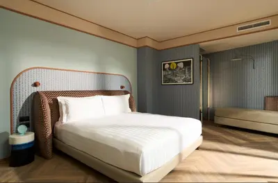 a bedroom with a white bed and a shower at Cloud 7 Roma Hotel in Rome
