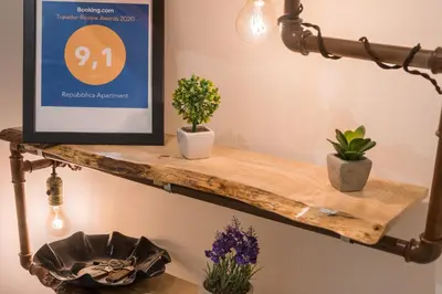 a wooden shelf with plants and a sign on it at Repubblica Apartment in Rome