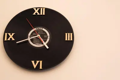 a black clock with gold numbers on a wall at Repubblica Apartment in Rome