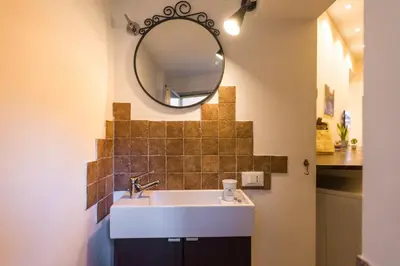 a bathroom with a sink and a mirror at Repubblica Apartment in Rome