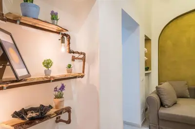 a living room with wooden shelves and a couch at Repubblica Apartment in Rome