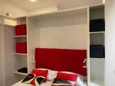 a bedroom with a bed with a red headboard at La perla del Colosseo in Rome