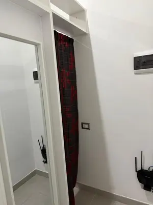 a red curtain in a room with a mirror at La perla del Colosseo in Rome