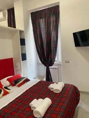 a bedroom with a bed with towels on it at La perla del Colosseo in Rome