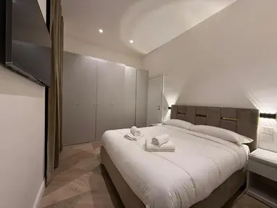 a bedroom with a large bed with towels on it at Luxury apartments, Piazza di Spagna in Rome